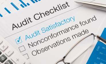 Auditor working through a compliance checklist