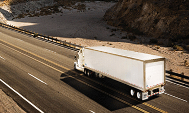 Freight truck travelling a North American highway at dusk